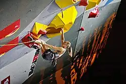 Climber on an artificial wall at the World Championships