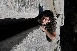 A climber doing the body jamming technique