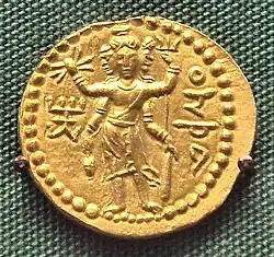 Three-faced four-armed Oesho with attributes, often identified with Shiva, on a coin of Huvishka.[60]