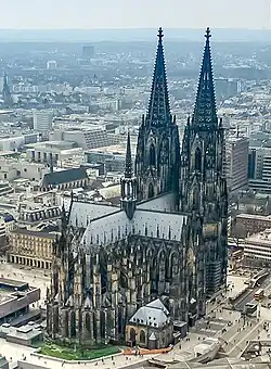 An aerial view shows the cruciform plan.