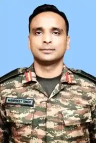 Color passport size photograph of a middle aged man wearing an army uniform.