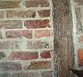Detail of construction technique, Cousin House. Photo shows original construction, c. 1787–1789. The bricks were made on site. The cypress beams are also believed to have come from the site. The mortar is clay. The plaster, shown over parts of the mortar, consists of human and horse hair, Spanish moss, and other materials.