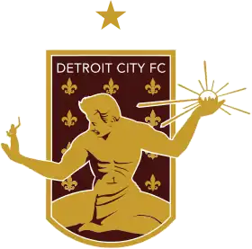 A shield containing The Spirit of Detroit, several Fleurs-de-lis, and the text "DETROIT CITY FC".
