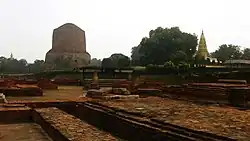 As it appeared in 2019. Camera angle from the ruins of the ancient Mulagandha Kuti Vihar towards the Dhamek Stupa; the Shreyanshnath Jain Temple can be seen on the right side of the photograph (the Panchayatan Temple can also be seen in the middle).