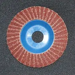 Flap disk. It is rough and made of sandpaper for sanding surfaces such as iron and wood