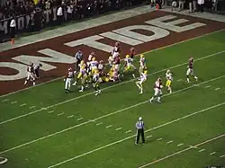 American football players after to running a field goal play.