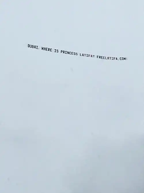 Banner against a cloudy sky, reading: DUBAI, WHERE IS PRINCESS LATIFA? FREELATIFA.COM