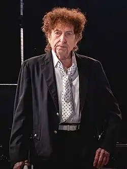 Bob Dylan standing on stage