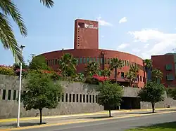 A reddish building seen across a street.