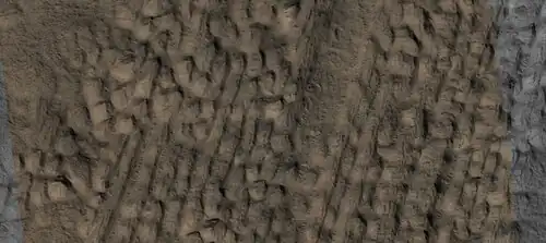 Close view of lineated valley fill (LVF) in valley, as seen by HiRISE under HiWish program. Linear valley flow is ice covered by debris. Picture is about 1 km wide.