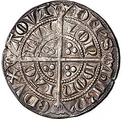 Silver coin with a design featuring a cross