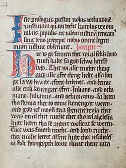 An old manuscript with thick blackletter font with some blue- and red-colored writing in some spots