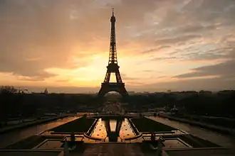 The Eiffel Tower silhouetted by a sunrise.