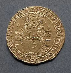 Gold coin showing a man seated on a chair