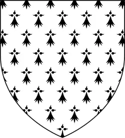 A shield shape. Inside the shield is a white background with black ermine symbols.
