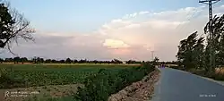 Evening sky above a road from Anbar to Hund, winding through fertile fields.