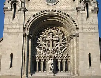 Rose window and statue of the Virgin Mary above the central portal