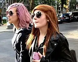 Two young women in Germany wearing round sunglasses, and casual monochrome streetwear typical of Tumblr inspired fashion, 2014.