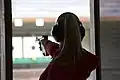 Female athlete competes in 25 meter pistol event.