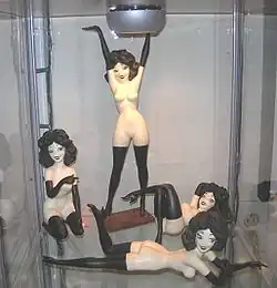 Four small Femlin statuettes displayed side by side