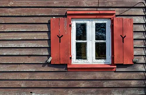 Window with shutters of the Lutheran wooden church in Born auf dem Darß (Germany)