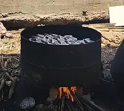 a round metal open fire with small fish