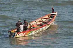 Brightly painted fishing boats are common in Bakau
