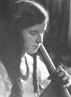 Flori Gough, a 12-year-old girl with long dark hair, playing a cello