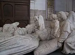 The portraits of the deceased, Francis and Margaret, on the tomb, their heads supported on pillows by angels