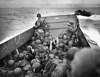 French Coast Dead Ahead, Sargent's photograph of U.S. Army troops crouching behind the bulwarks of a landing craft as it nears Omaha Beach on D-Day