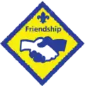 Diamond yellow and blue badge with two hands shaking: Friendship challenge