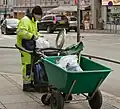 Street sweeper emptying the city's trash cans