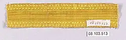 A length of plain, bright gold braid with a zigzag border