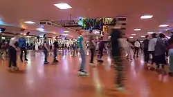 2022 "Gay Skate" event at the Oaks Park Roller Skating Rink, featuring music and a disco ball