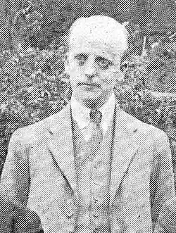 Black-and-white photographic portrait of a gentleman in a suit