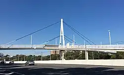 A cable-stayed footbridge over a freeway