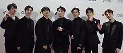 An image of GOT7, all wearing a black suit.