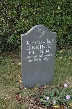 A gravestone depicting a figure as well as the inscription of Robert Yewdall Jennings.