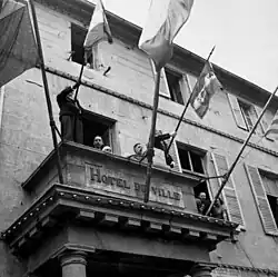 Charles de Gaulle delivering a speech in liberated Cherbourg from the Hôtel de Ville (town hall)