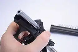 Heckler & Koch P7K3 using the exchange tool to tighten to barrel nut to install a .32 ACP barrel