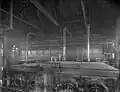 A black-and-white photo of the inside of the station, with pipes going into a machine.