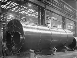 Lancashire boiler 1900, painted with a protective coating, the mountings such as safety valves, stop valve, feed check valves and water level gauges, have been removed.[120]