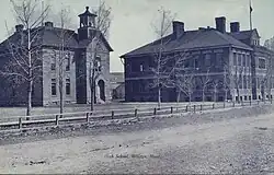 An old, black-and-white postcards of two brick school buildings.