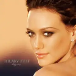 The face and shoulders of a young woman looking over her left shoulder. She has brown hair and wears small crystal earrings. To the left of her image, the words "Hilary Duff" are written in silver, capital letters, with "Dignity" in silver, italic, cursive letters below that.