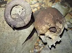Human skull and an iron currency bracelet found at the bottom of Iroungou cave in Gabon