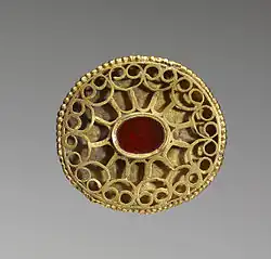 A Hunnish oval openwork fibula set with a carnelian and decorated with a geometric pattern of gold wire, 4th century, Walters Art Museum