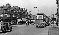 Photograph of a street with trolleybuses and a police box on the pavement
