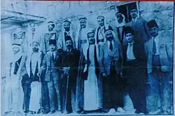 Blue-tinted outdoor photo of a group of men