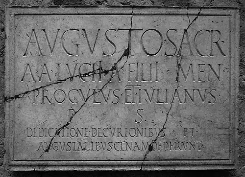 Inscription displaying very thin apices and long i. Herculaneum, 1st century CE. avgvstó · sacr / a · a · lv́ciꟾ · a · fꟾliꟾ · men procvlvs · et · iv́liánvs p · s dédicátióne · decvriónibvs · et avgvstálibvs · cénam · dedérvnt