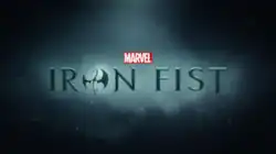 Iron Fist written in black writing, the letter O written in the form of a stylized dragon.